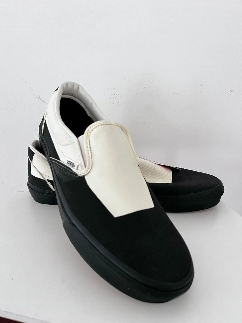 VANS  Slip-On in a black and classic CREAM colorway